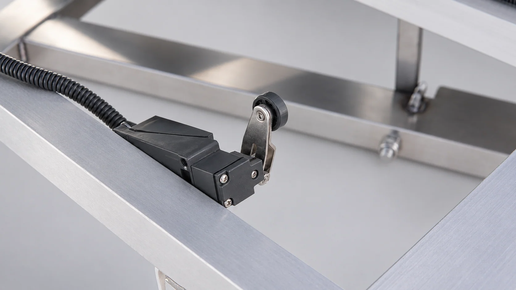 Roller limit switch mounted on the silver base frame